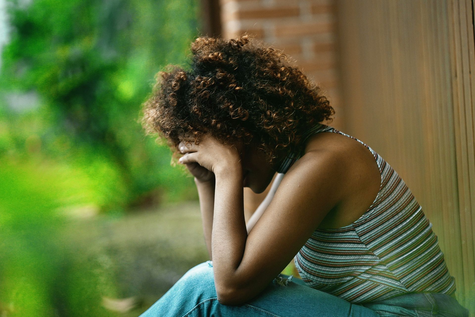 Woman grieving with her head in her hands